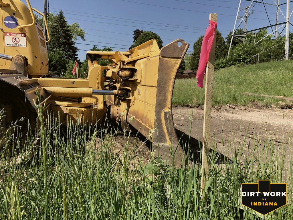 Dozer blade grading topsoil